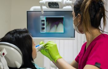 A dentist performing oral and teeth screening.